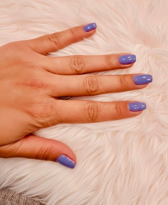 Short square nails in a glossy periwinkle blue gel polish